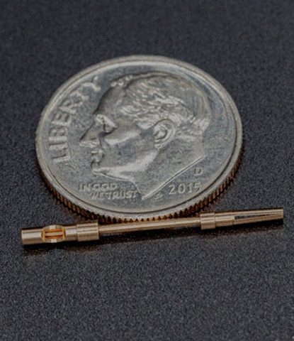 Tiny copper telecom connector with dime for scale