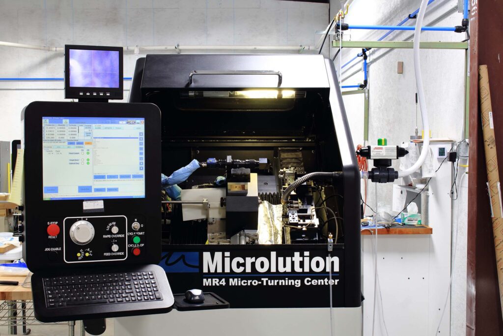 Micro-turning machine with control panel interface.